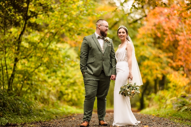 A bride and groom embracing in a garden