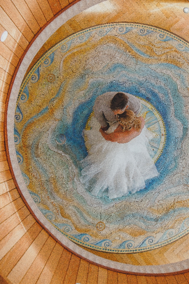 A man and woman dancing on a colourful mat