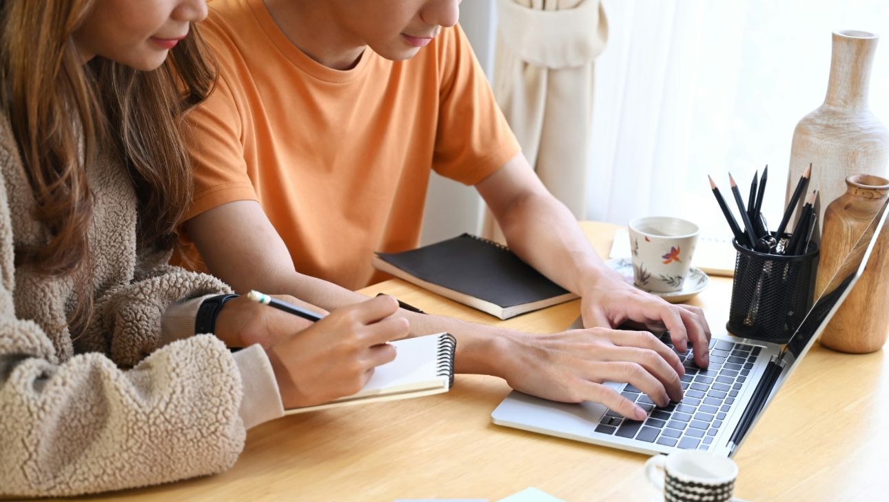 couple at table and laptop